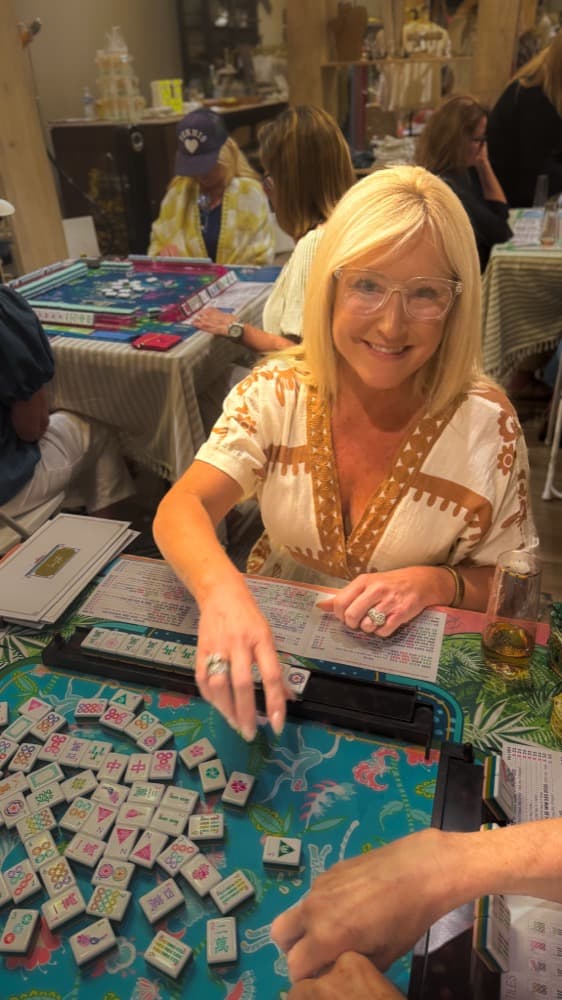 A student learning Mahjong at Anissa's Threadz Boutique